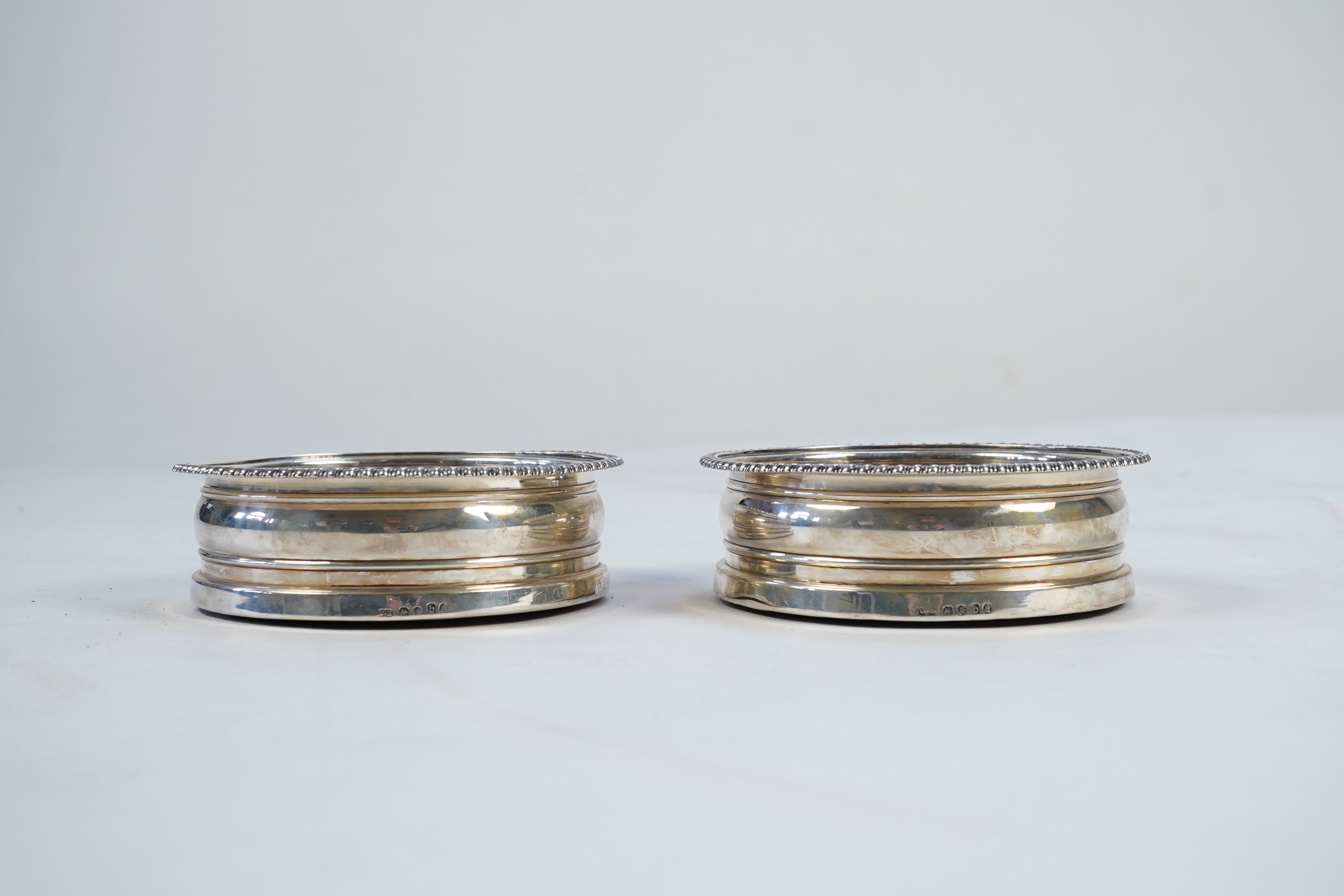 A pair of late George III silver wine coasters, by William Bateman